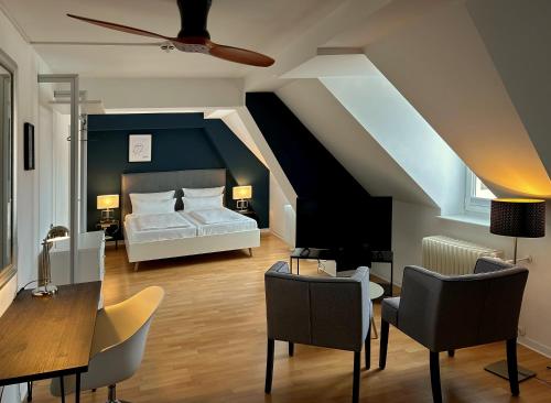 ハイデルベルクにあるDK Hotel Deutscher Kaiserのベッドルーム1室(ベッド1台、テーブル、椅子付)