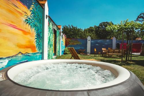 eine Badewanne mit Wasser vor einem Wandbild in der Unterkunft Apartmány Natálie in Franzensbad