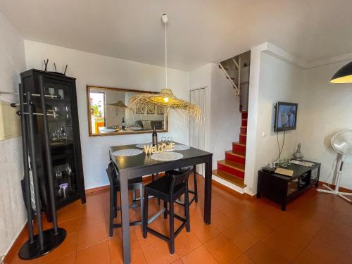 a dining room with a black table and chairs at Évora City Break Apartment with Patio in the Historic Centre in Évora