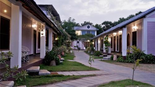 a row of houses at night at Lahe by Loka in Auroville