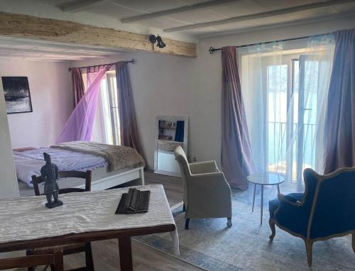 a bedroom with a bed and a table and chairs at Nido con vista sul lago in Brissago