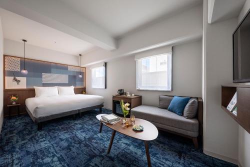 Ein Bett oder Betten in einem Zimmer der Unterkunft Estinate Hotel Naha