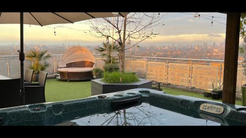 a view of a building with an umbrella and a city at The OMG penthouse in London