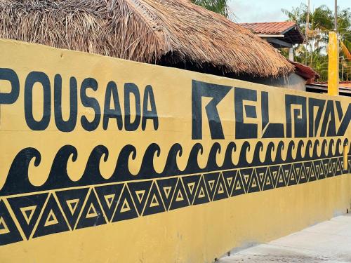 eine gelbe Wand mit einem Schild, das die Pueblania-Küche liest in der Unterkunft Pousada Reloday in Salvaterra