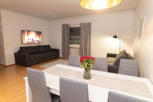 a living room with a table and a couch at Lapinmaa Apartments in Rovaniemi