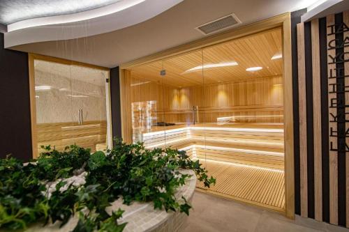 a sauna with wooden walls and plants in a room at Apartman Lux Titova Vila Plus Sony PS in Zlatibor