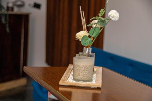 a vase with flowers in it on a table at Occidental Wise Transit in Bucharest