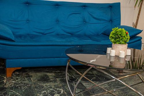 a living room with a blue couch and a table at Occidental Wise Transit in Bucharest