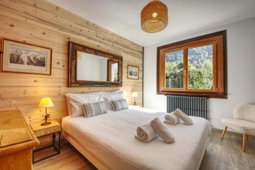 a bedroom with a large bed and a window at Chalet Sol in Chamonix