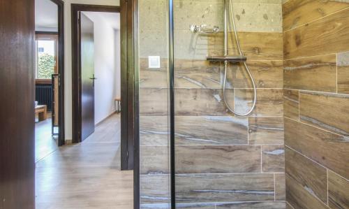 a bathroom with a shower with wooden walls at Chalet Sol in Chamonix
