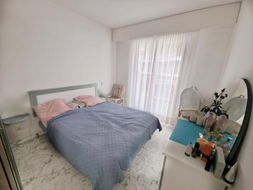 a bedroom with a bed and a large window at 1 meter from Monaco. 5 min by elevators to Larvotto beach. in Beausoleil
