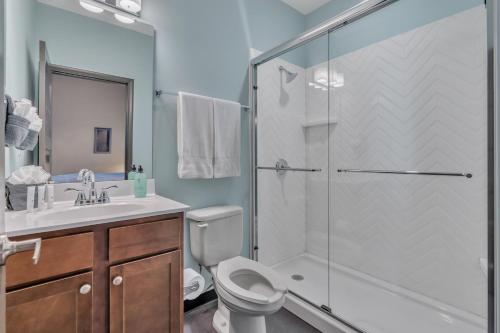 a bathroom with a shower and a toilet and a sink at Hoppy Hideaway: Coastal Loft with a Brewery Twist in Myrtle Beach