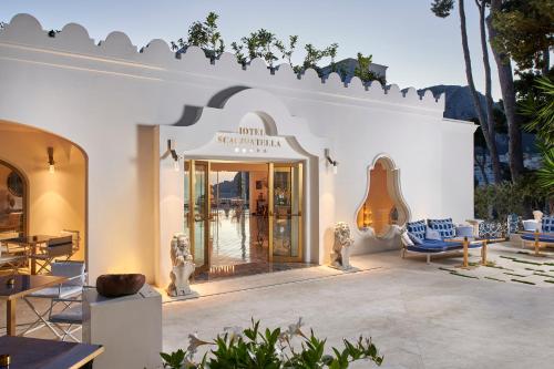 a white building with a store front with a guitar at Hotel Scalinatella in Capri