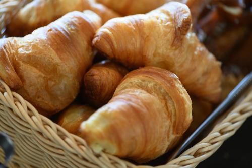a basket filled with croissants and other pastries at IntercityHotel Herford in Herford