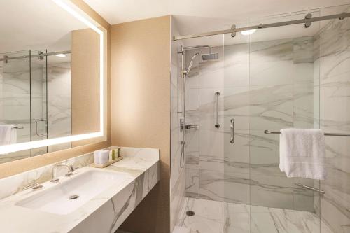 a bathroom with a sink and a glass shower at Signia by Hilton San Jose in San Jose