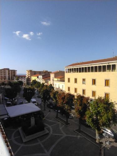 a view of a courtyard with trees and a building at B&B dal Cardinale in Ozieri