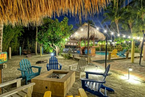 a resort with chairs and a table and a pool at Siesta Key Palms Resort in Sarasota