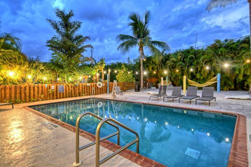 a pool at night with chairs and a slide at Siesta Key Palms Resort in Sarasota