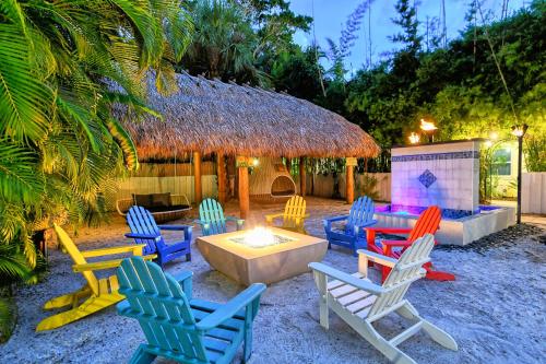 a group of chairs sitting around a fire pit at Siesta Key Palms Resort in Sarasota