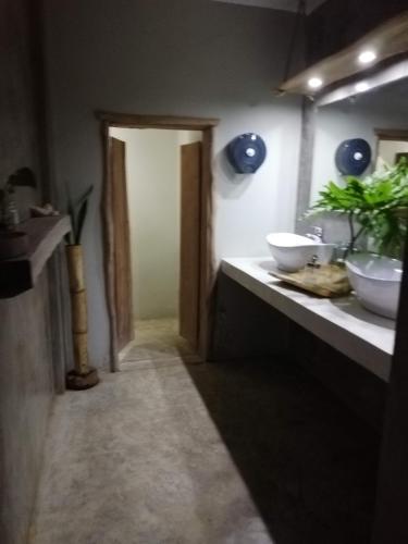 a bathroom with two sinks and a mirror at Residencia El Balatà in Las Terrenas