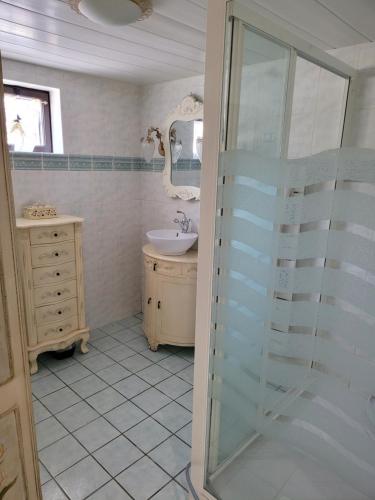 a bathroom with a glass shower and a sink at TL 26 - Sous les palmiers au soleil in Eu