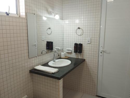 a bathroom with a sink and a mirror at Gurgueia Park Hotel in Cristino Castro