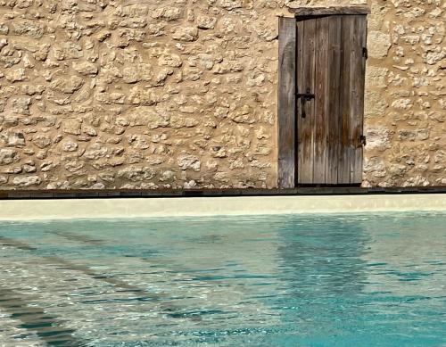 a door in the side of a building with water at Richard Lequet Domaine gastronomique du Val d Atur in Boulazac