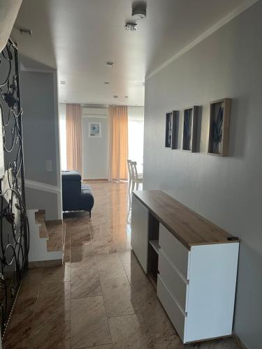 a living room with a desk and a chair at Merkel Villa Apartamente in Wiesbaden