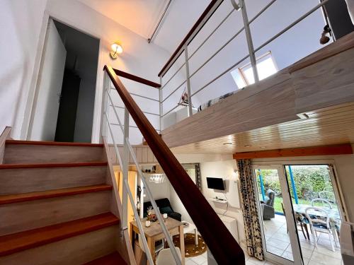 a house with a staircase and a living room at Keraven, charmante maisonnette, piscine commune 1-4 personnes in Moëlan-sur-Mer