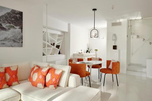 a living room with a couch and a dining room at Hotel Scalinatella in Capri