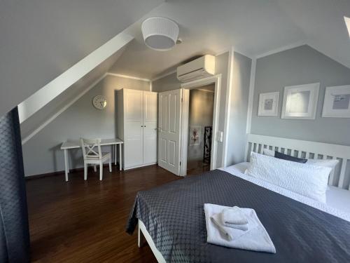 a bedroom with a bed and a desk and a table at Merkel Villa Apartamente in Wiesbaden