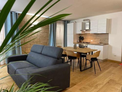 a living room with a blue couch and a table at ORVIETO ANTICA Apartment in Orvieto