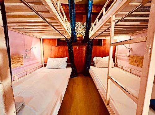 a room with two bunk beds in a boat at Havana Nights Phi Phi in Phi Phi Islands