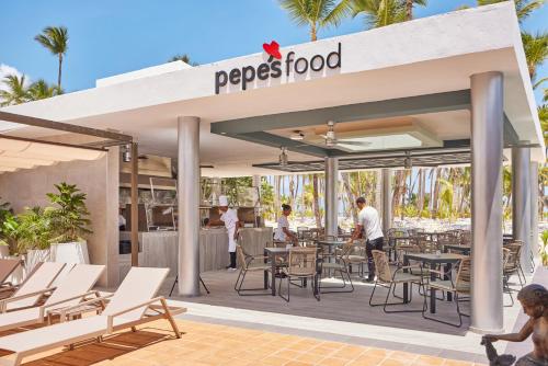 a rendering of a restaurant with tables and chairs at Riu Palace Macao - Adults Only - All Inclusive in Punta Cana