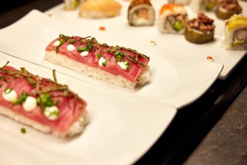 a plate of food on a table with sushi at Riu Palace Macao - Adults Only - All Inclusive in Punta Cana