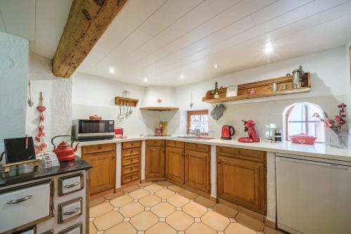 uma grande cozinha com armários e electrodomésticos de madeira em L Oriel du Rempart Nord em Eguisheim