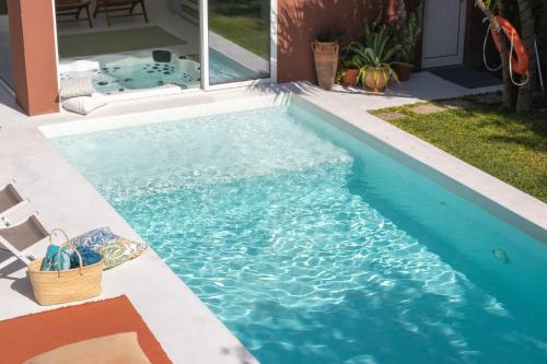 a swimming pool in the yard of a house at Casa dos Pinheiros 109 - Private Villa with pool & heated SPA in Porto
