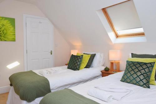 two beds in a room with a attic at Sandy Gem - Viking Bay Getaway in Kent