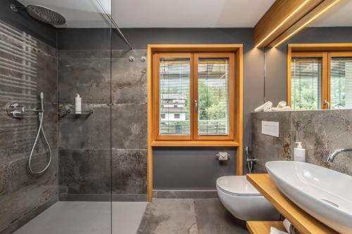 a bathroom with a shower and a toilet and a sink at Villa Margherita in Tenna 