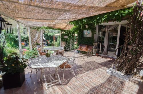 a patio area with a patio table and chairs at B&B Olbia in Olbia