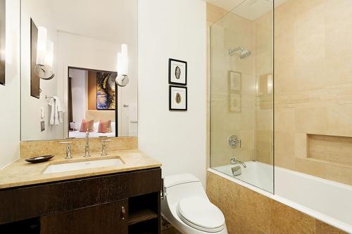 a bathroom with a toilet and a sink and a shower at Independence Square 207, Chic Studio in Downtown Aspen, 1 Block from Gondola in Aspen