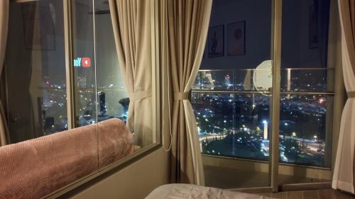 a room with a window with a view of a city at Premium The Sóng 5sao P Khánh Vân Homestay in Vung Tau