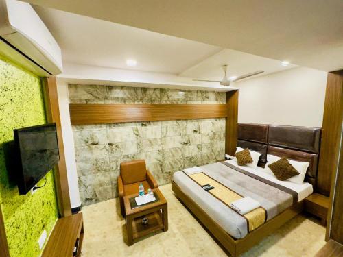a bedroom with a bed and a flat screen tv at Sheraton Grande Hotel - Business Class Hotel - Near Central Railway Station in Chennai