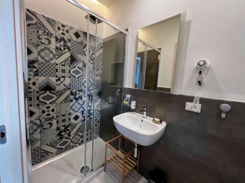 a bathroom with a sink and a shower at Sunset rooms in La Spezia