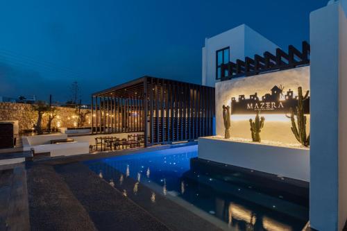 a hotel with a swimming pool at night at Laguna Suites in Mazera Mykonos in Mýkonos City