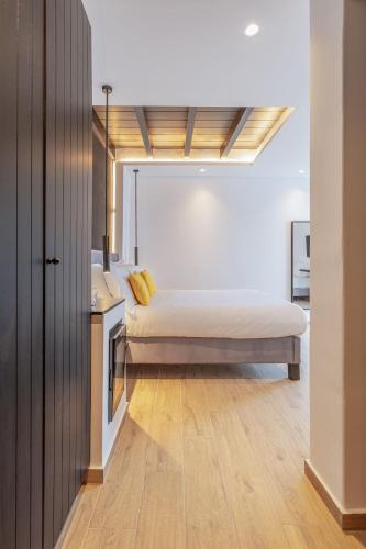 a bedroom with a bed and a sink in it at Laguna Suites in Mazera Mykonos in Mýkonos City