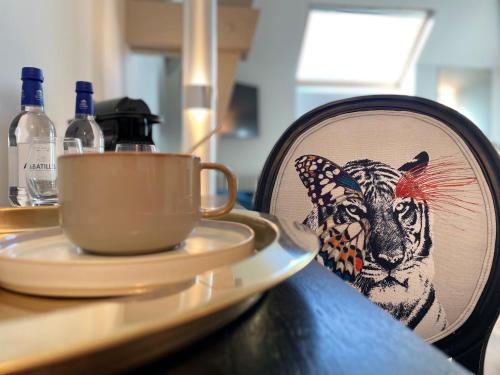 talerz ze zdjęciem tygrysa i kubkiem na stole w obiekcie Richard Lequet Domaine gastronomique du Val d Atur w mieście Boulazac