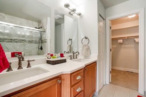 a bathroom with two sinks and a large mirror at Anchorage Retreat Charming Home with Private Deck! in Anchorage