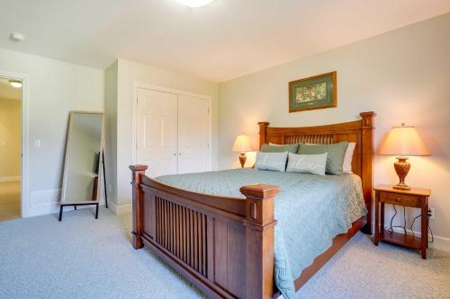 a bedroom with a bed and two lamps and a mirror at Anchorage Retreat Charming Home with Private Deck! in Anchorage