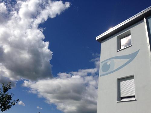 a building with a fish painted on the side of it at Pension Augenblick in Greifswald